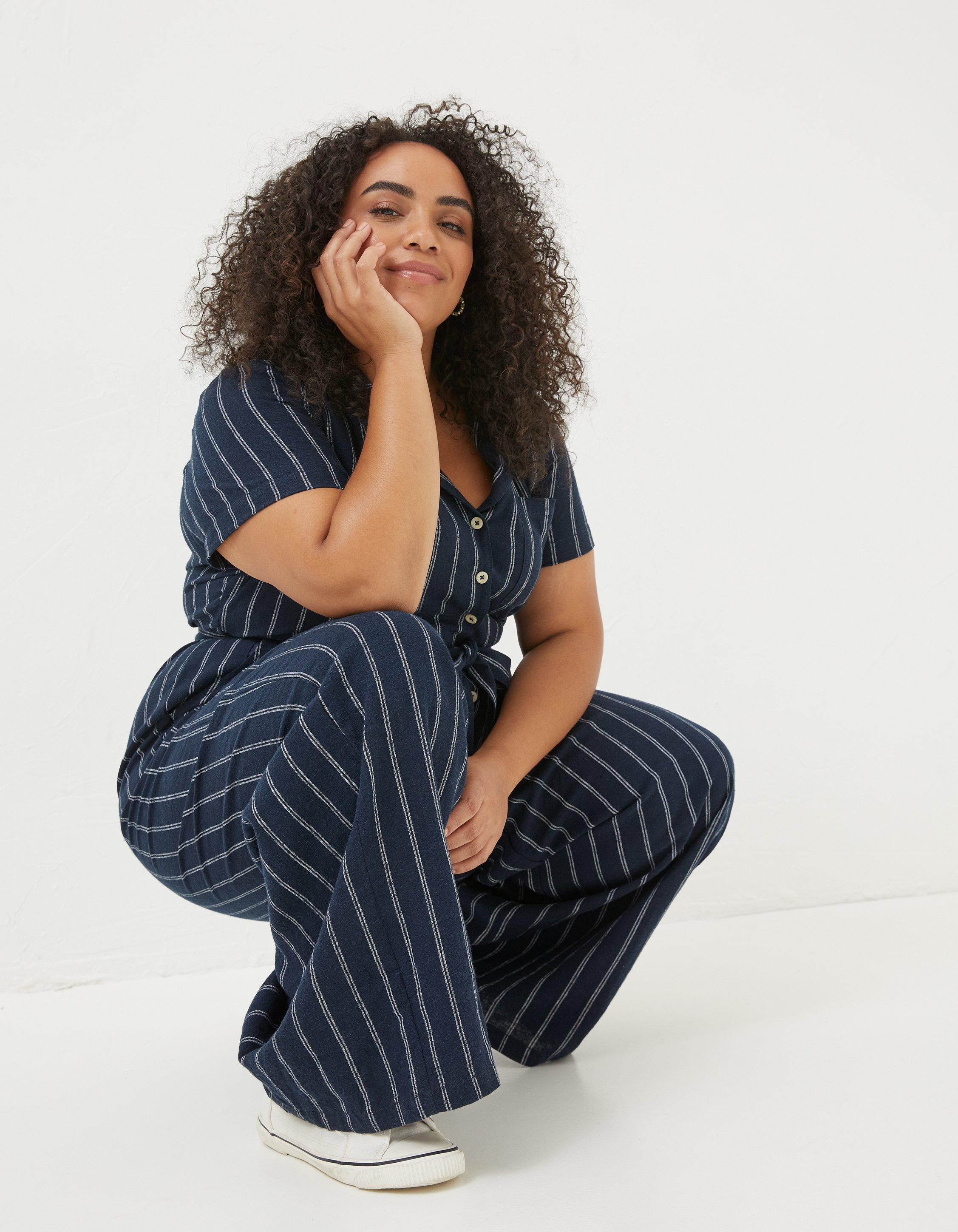 TOAST - DELAVE LINEN JUMPSUIT  Weighty delave linen, with a neat, gently  pointed collar. Bracelet-length sleeves, drawstring waist with self-fabric  ties to fasten. Dropped crotch, very wide, ankle-skimming trousers and  pockets